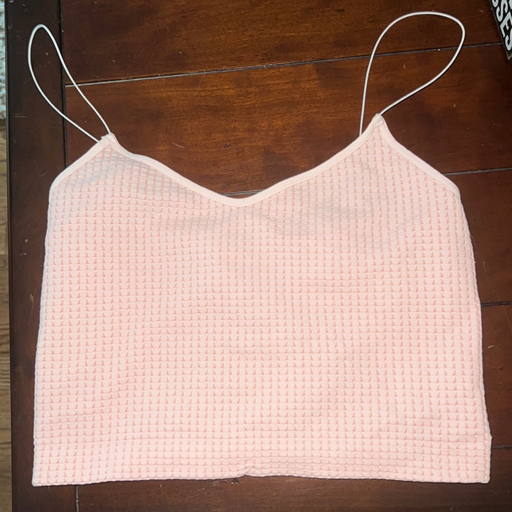 Pink cropped tank top with white cami straps.